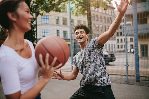 Streetball players on court playing basketball
