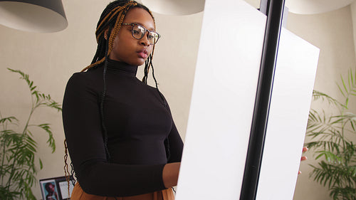 Young freelance photographer working in her home studio