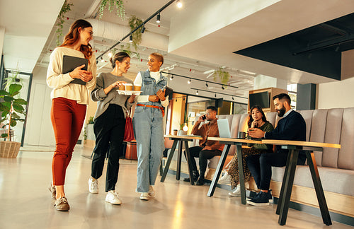 Businesswomen walking through a modern co-working space