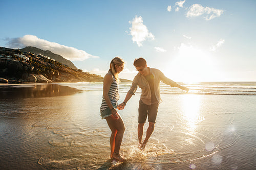 Beautiful young couple having fun on beach