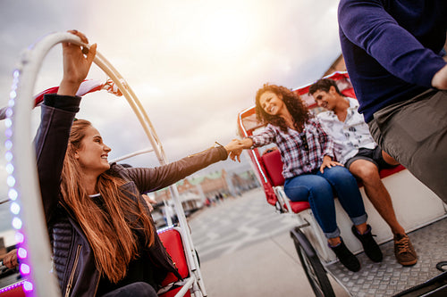 Teenage friends having fun on tricycles