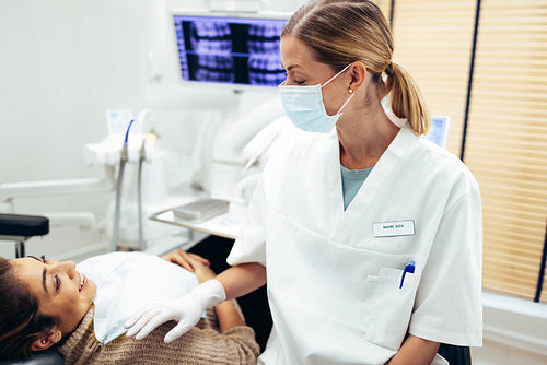 Dentist examining a female patient in clinic