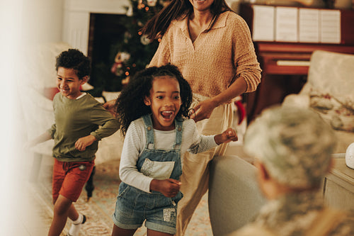 Ecstatic children running to welcome their dad from the army