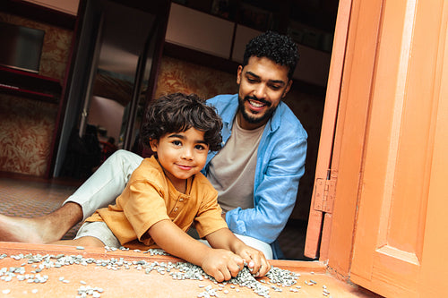 Father and child enjoying playtime at home together in a warm setting