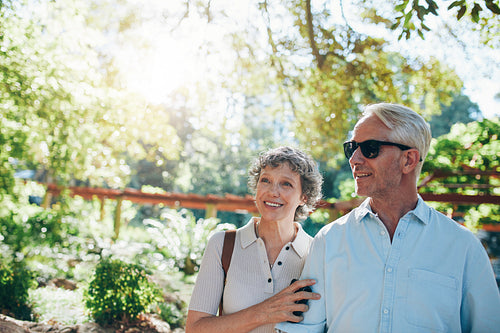 Happy mature couple standing together in a park