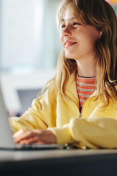 Excited to learn, young girl smiles as she pays attention to a lesson in a classroom