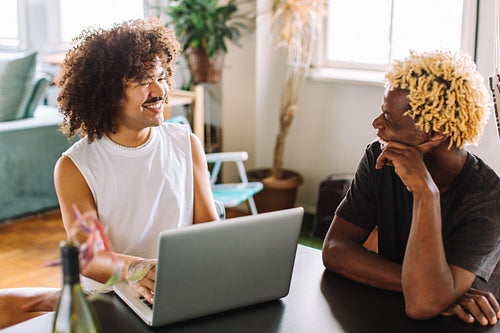 Gay couple having a cheerful chat together indoors