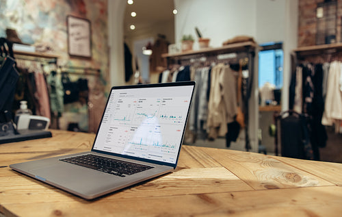 Laptop on checkout counter of clothing store