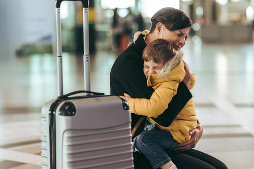 Emotional mother meeting her son at airport arrival