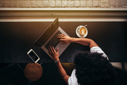 Man working on laptop at coffee shop