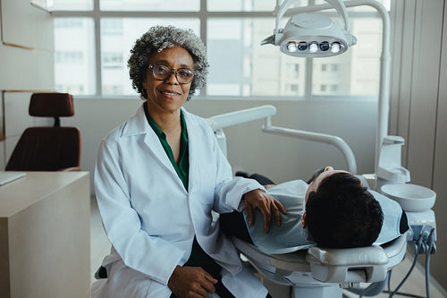 Female dentist reassures patient during consultation at a modern dental clinic