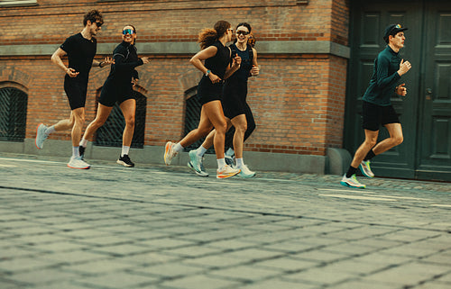 The running team moves with group energy through the city