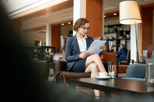 Businesswoman reading document at coffee shop