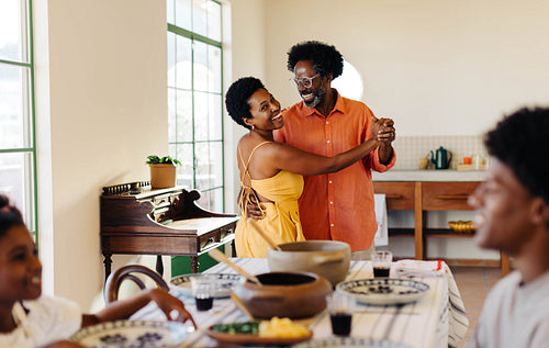Brazilian family enjoying traditional feijoada meal together at home