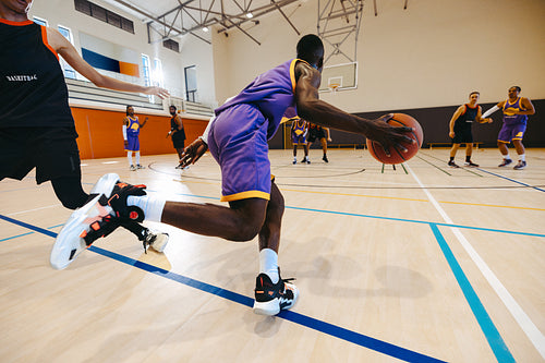 Basketball game action with players in motion on a gym court
