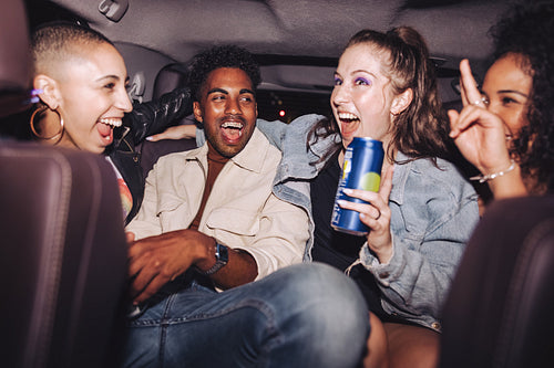 Friends having fun in the back seat of a car