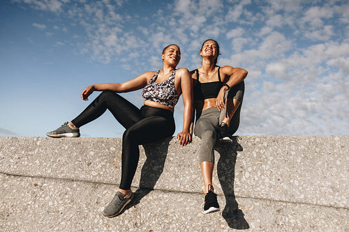 Two fitness females relaxing after workout