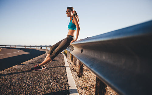 Happy woman relaxing after a morning run
