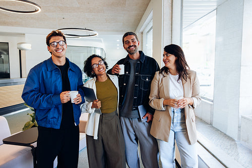 Coworkers smiling together as a relaxed office team