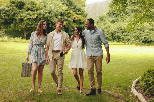 Group of friends going on picnic at park