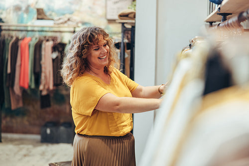Happy woman working in a fashion store