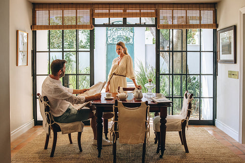Woman chatting with her husband in a hotel dining area