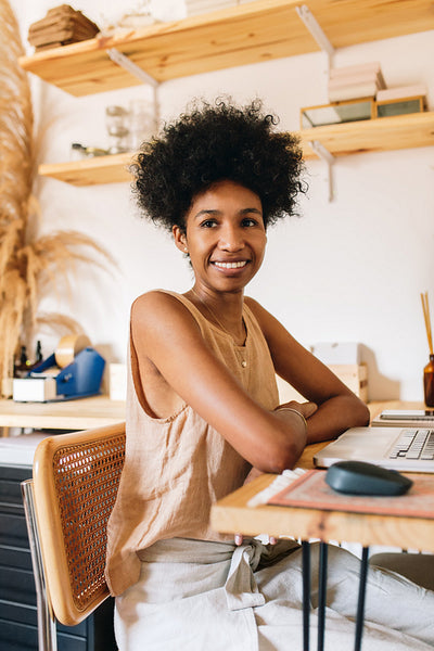 Happy jewelry entrepreneur in office