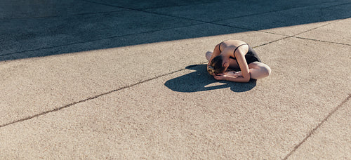 Female ballet dancer warming up before the practice