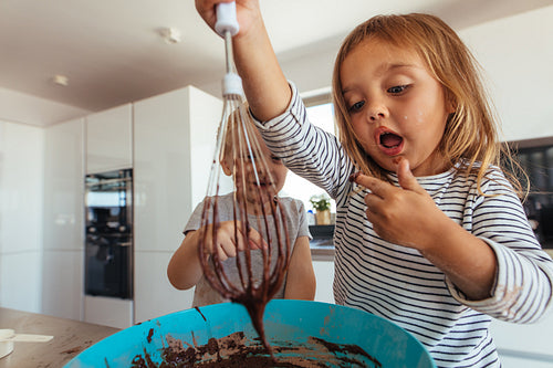 Young couple tasting the cake batter