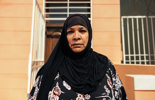 Middle-aged Muslim woman looking at the camera outdoors