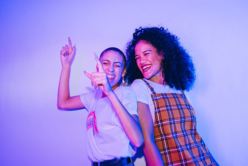 Best friends dancing to their favourite song at a party