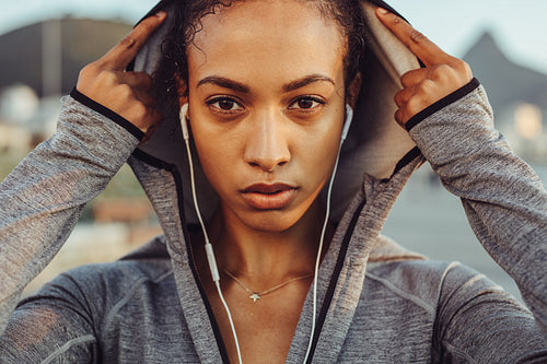 Confident female runner in a hoodie