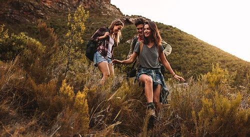 Young people hiking on a rough terrain
