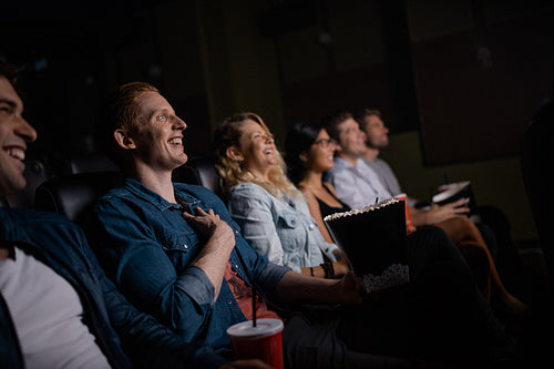 Young people watching movie in cinema