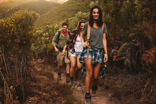 Friends hiking on rugged hilly terrain