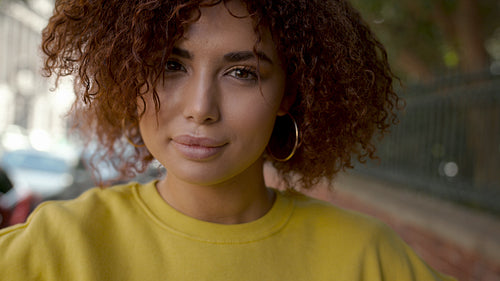 Confident girl looking at camera with a smile