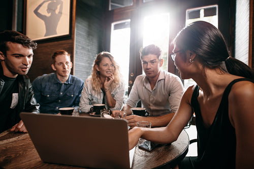 Sharing some ideas on laptop with friends