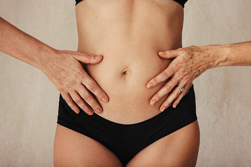 Anonymous aging female body in black underwear