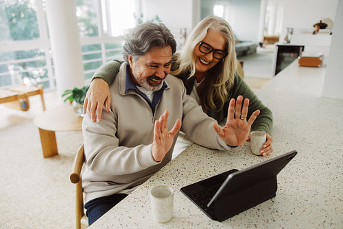 Woman joins senior partner for a video chat at home