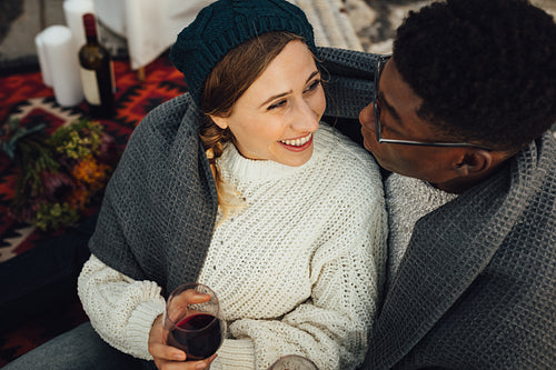 Happy interracial couple enjoying picnic