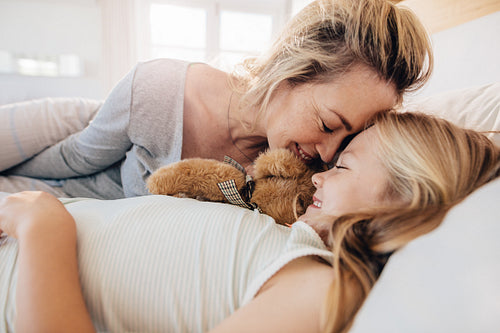 Mother and daughter sleeping together