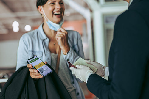 Female traveling with vaccine passport at airport