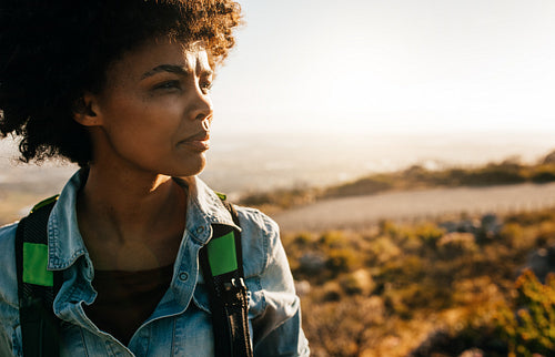 Young african female hiker standing in nature