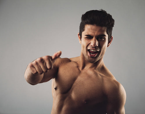 Happy masculine man showing thumbs up sign