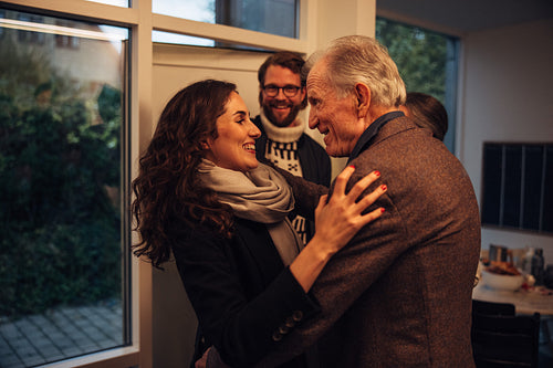 Family visiting grandparents for christmas dinner