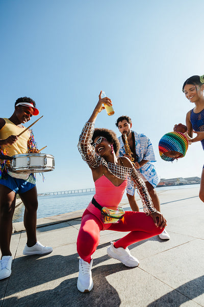 Carnival friends dance on sunny beach