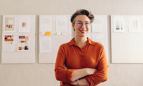 Happy interior designer smiling at the camera in her office
