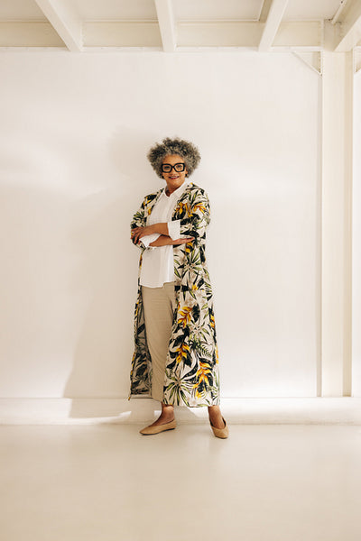 Mature businesswoman standing against an office wall