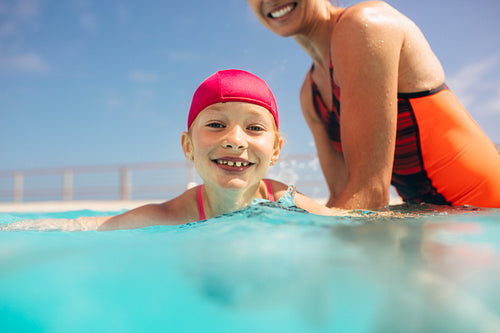 Girl learning to swim in the pool
