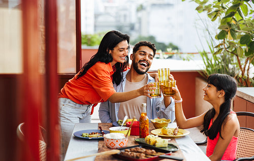 Happy family enjoying a meal together on a sunny outdoor patio